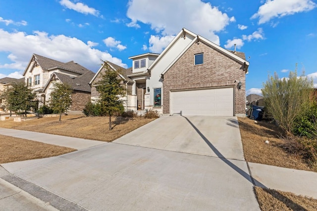 view of front of home with driveway, an attached garage, and brick siding