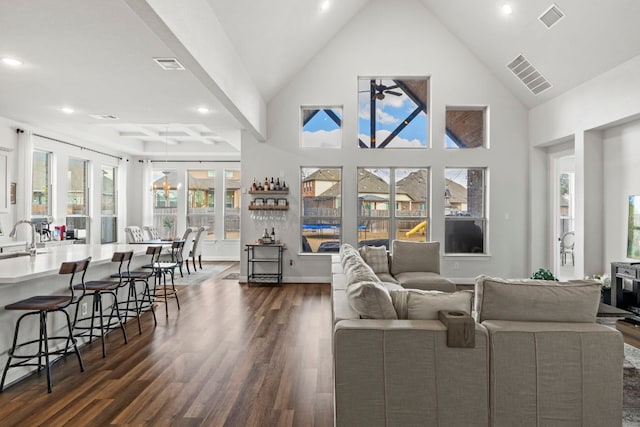 living room with a ceiling fan, dark wood-style flooring, and visible vents