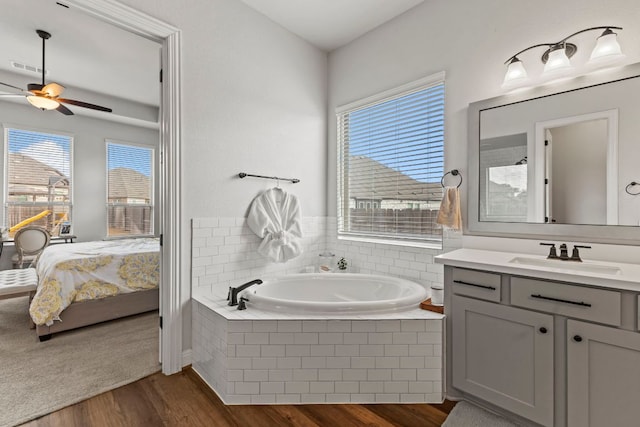 ensuite bathroom featuring ensuite bath, visible vents, a bath, and wood finished floors