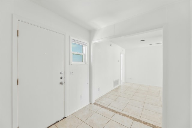 empty room featuring light tile patterned flooring and visible vents