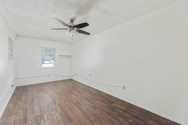 unfurnished room with ceiling fan, a textured ceiling, baseboards, and wood finished floors