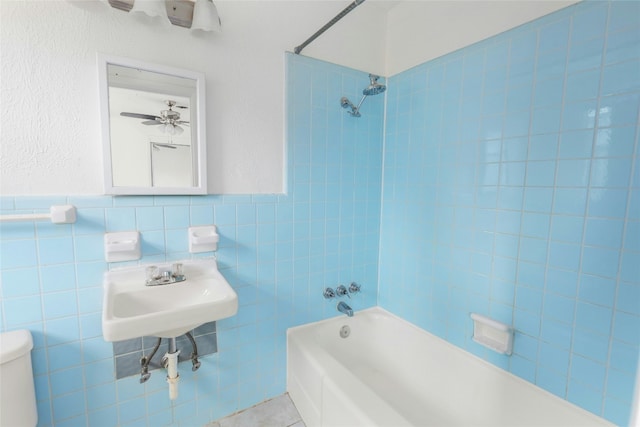 full bath featuring toilet, tile patterned flooring, shower / washtub combination, and tile walls