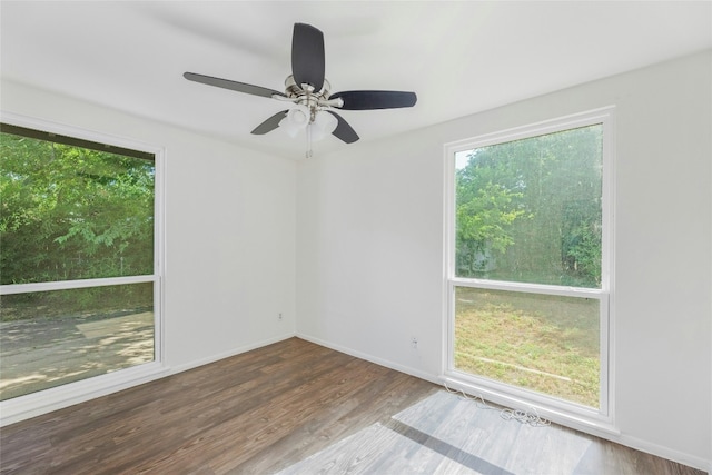 unfurnished room with baseboards and wood finished floors