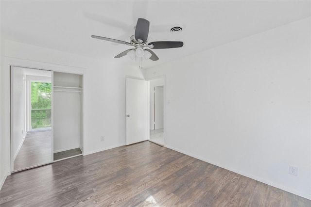 unfurnished room featuring visible vents, ceiling fan, baseboards, and wood finished floors