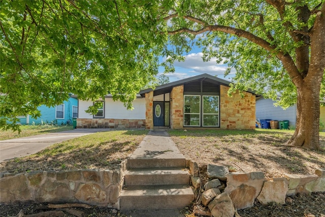 mid-century inspired home with stone siding