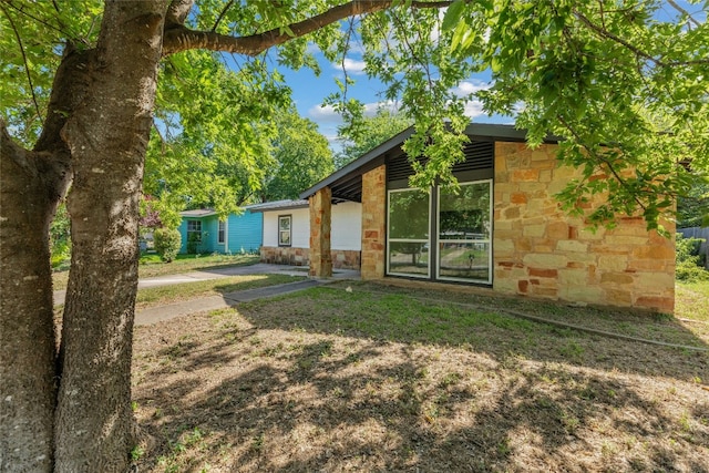 back of house with stone siding