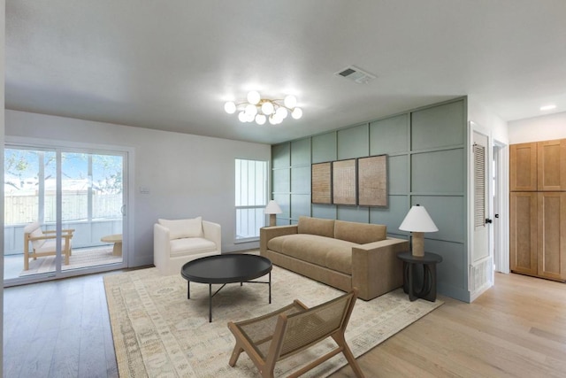 living area featuring light wood finished floors and visible vents