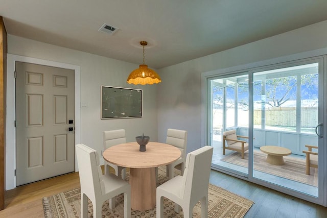 dining space featuring visible vents and light wood finished floors