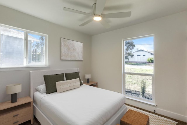 bedroom featuring ceiling fan and baseboards