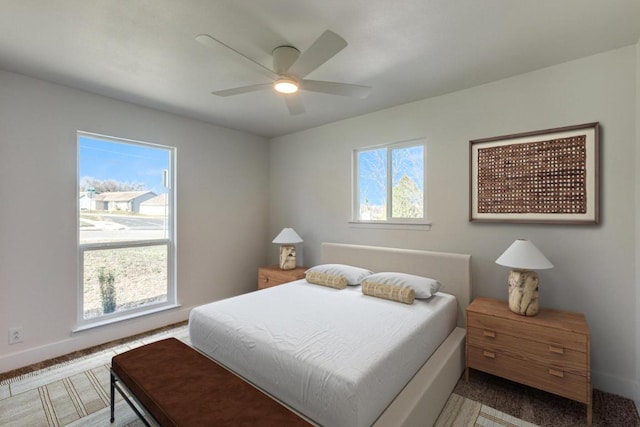 bedroom with a ceiling fan and baseboards