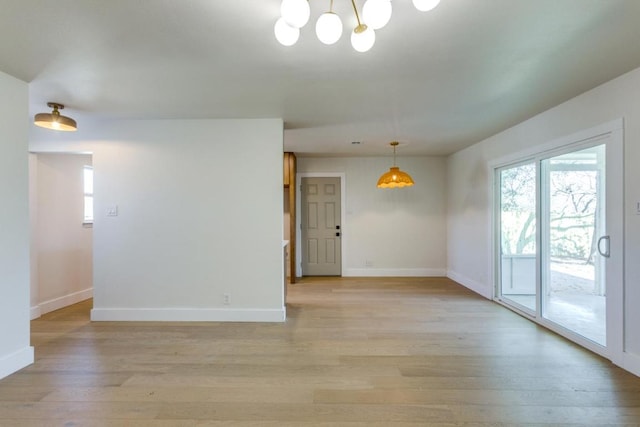 6401 Cooper Ln, Austin, TX 78745 - spare room with light wood-style flooring, baseboards, and a chandelier