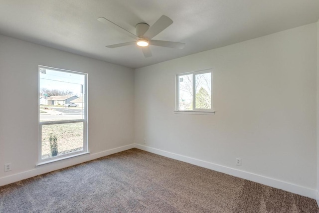 empty room featuring carpet floors, ceiling fan, and baseboards