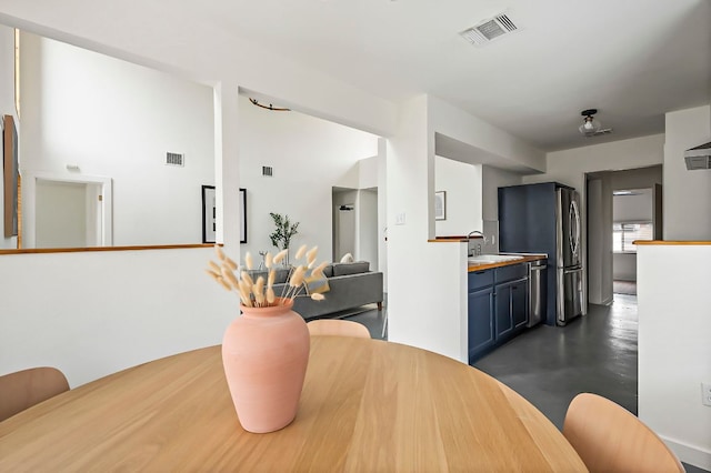 dining area with finished concrete floors and visible vents