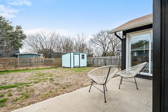 view of yard featuring an outbuilding, a shed, a patio area, and a fenced backyard