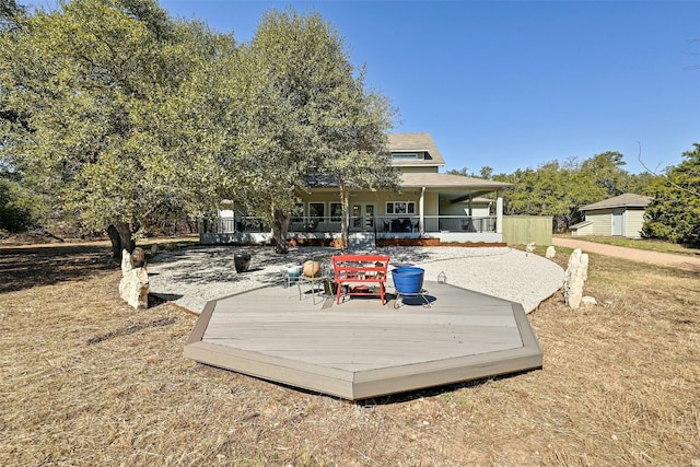 back of property featuring a deck