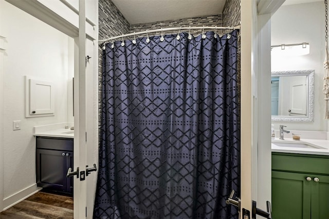 full bath with vanity, a shower with shower curtain, wood finished floors, and baseboards