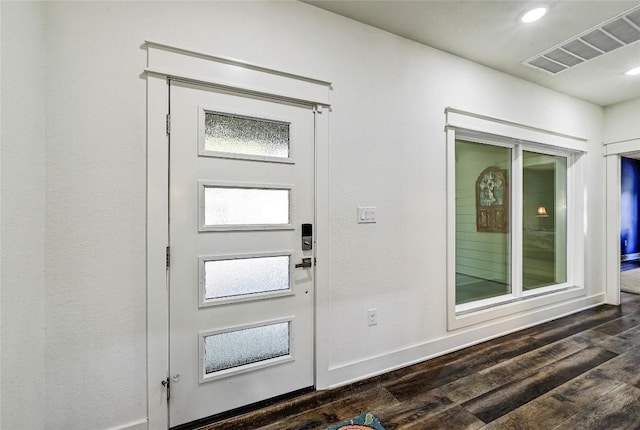 interior space featuring dark wood finished floors, visible vents, recessed lighting, and baseboards