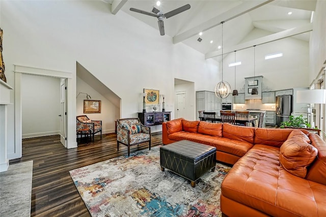 living room featuring high vaulted ceiling, ceiling fan with notable chandelier, baseboards, beam ceiling, and dark wood-style floors