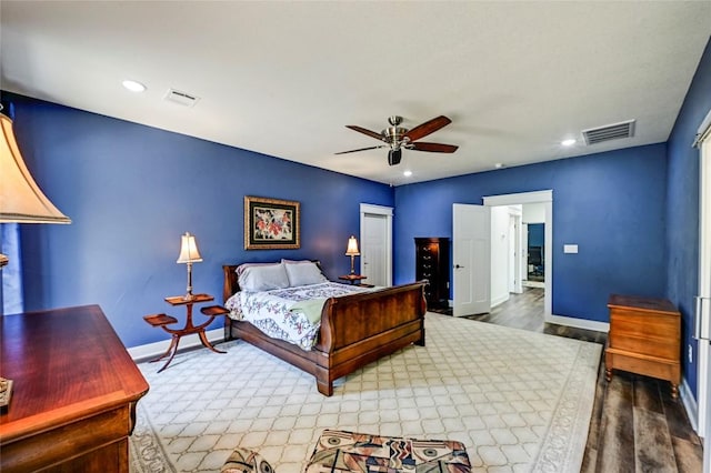bedroom featuring recessed lighting, visible vents, baseboards, and wood finished floors