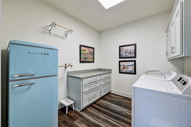 laundry room with baseboards, cabinet space, dark wood finished floors, and washing machine and clothes dryer