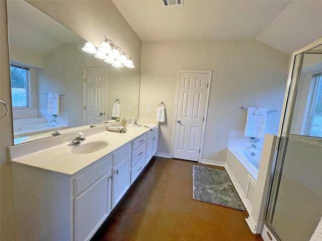 bathroom with lofted ceiling, double vanity, a sink, and a garden tub