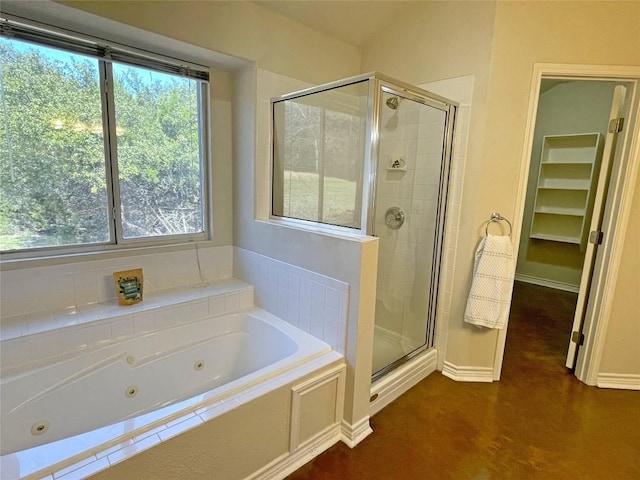 full bathroom featuring a tub with jets and a shower stall