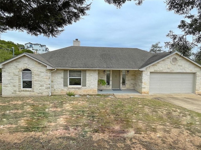 ranch-style home with concrete driveway, roof with shingles, a chimney, and an attached garage