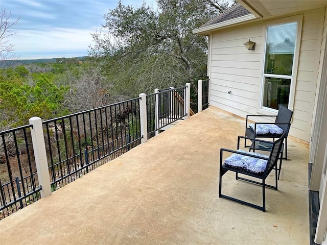 view of patio / terrace featuring a wooded view