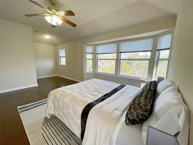 bedroom featuring lofted ceiling, a ceiling fan, visible vents, and baseboards