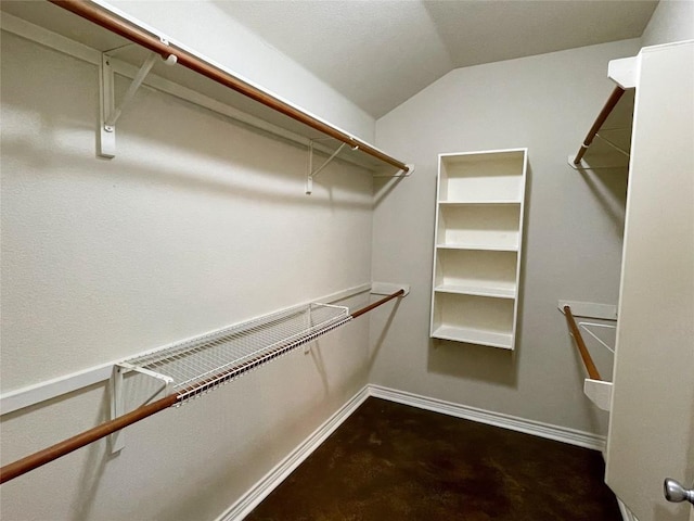 walk in closet featuring vaulted ceiling