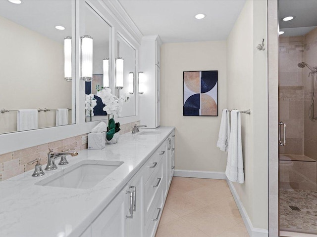 full bath with tile patterned flooring, a shower stall, baseboards, and a sink