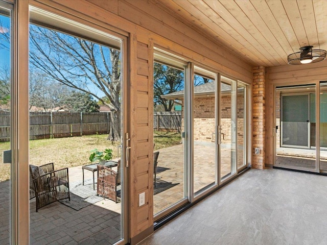 unfurnished sunroom featuring wooden ceiling