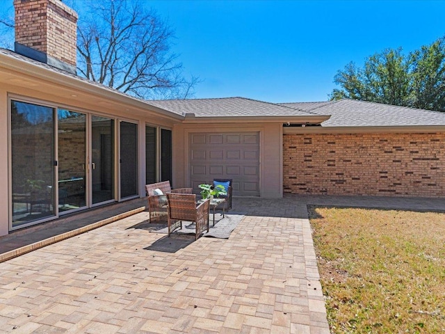 view of patio / terrace featuring a garage