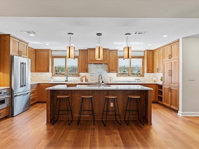 kitchen featuring a sink, light countertops, visible vents, and stainless steel appliances