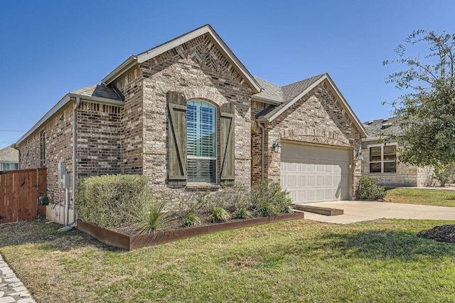 french provincial home featuring driveway, an attached garage, fence, a front lawn, and brick siding