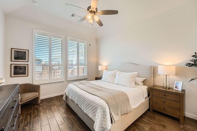 bedroom featuring a ceiling fan, visible vents, dark wood finished floors, and baseboards