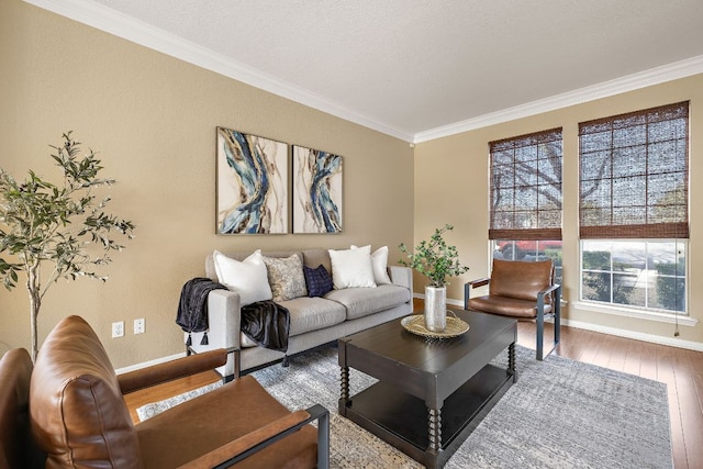 living area featuring crown molding, baseboards, and hardwood / wood-style flooring