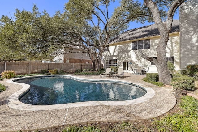 view of swimming pool featuring a fenced in pool, a fenced backyard, and a patio