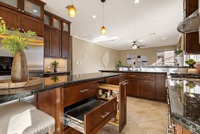 kitchen with light tile patterned flooring, a peninsula, stainless steel fridge with ice dispenser, tasteful backsplash, and decorative light fixtures