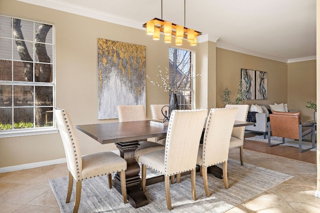 dining area with ornamental molding, tile patterned flooring, a wealth of natural light, and baseboards