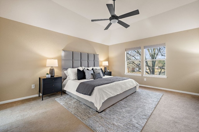 carpeted bedroom with vaulted ceiling, a ceiling fan, and baseboards