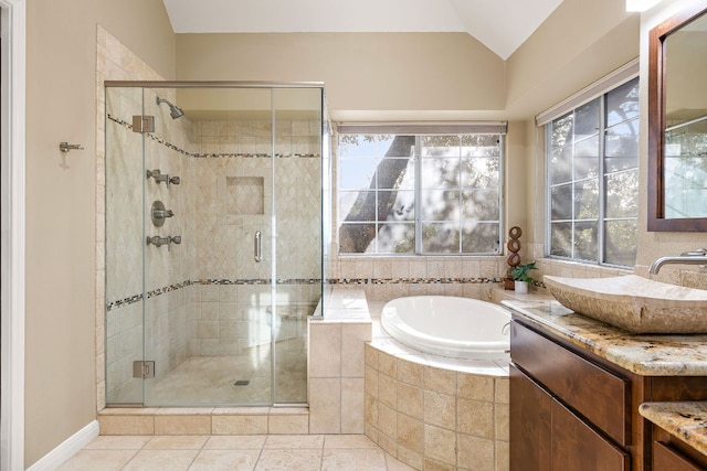 bathroom with a garden tub, vanity, vaulted ceiling, a shower stall, and tile patterned floors