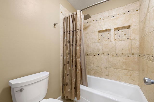 bathroom featuring shower / bath combination with curtain and toilet