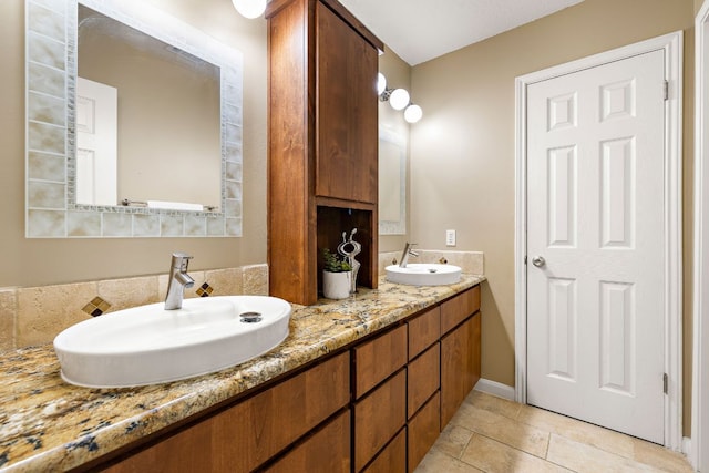 full bath featuring tile patterned flooring, a sink, and double vanity