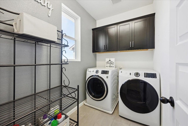 laundry area featuring cabinet space, separate washer and dryer, baseboards, and visible vents