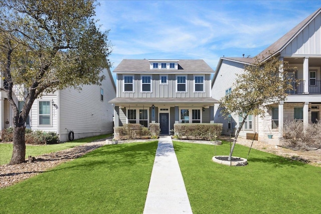 view of front of house with board and batten siding and a front yard