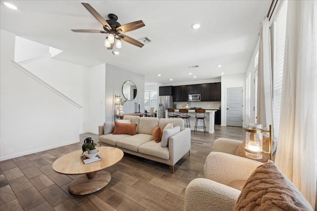 living area featuring visible vents, wood finished floors, recessed lighting, baseboards, and ceiling fan