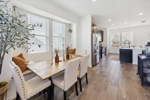 dining space featuring recessed lighting and wood finished floors
