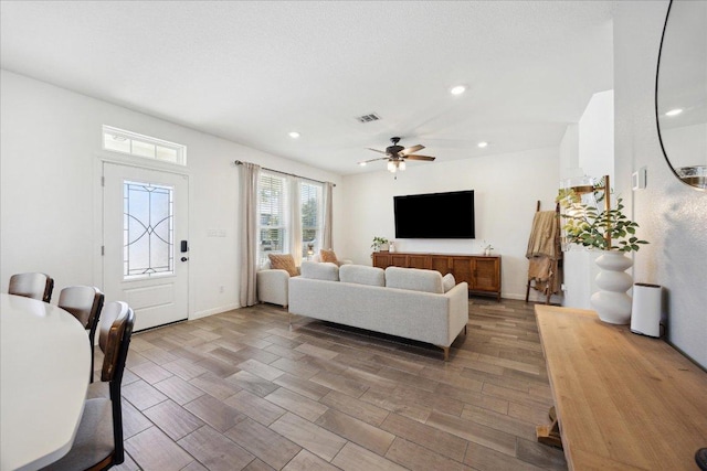 living room with visible vents, baseboards, ceiling fan, recessed lighting, and wood finished floors