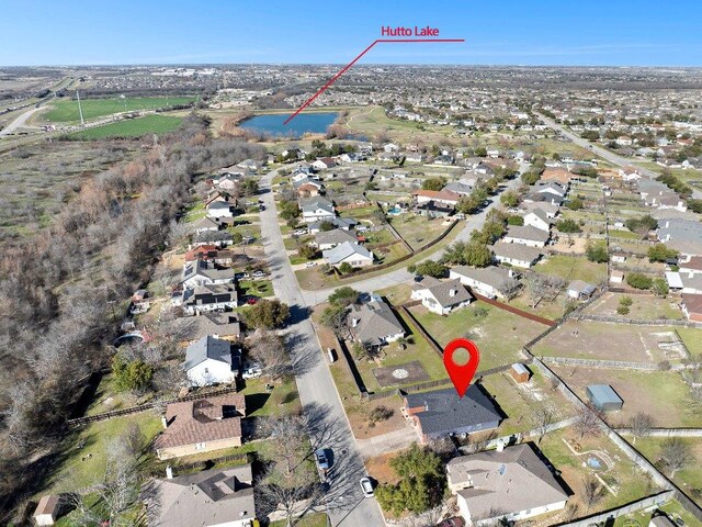 drone / aerial view with a water view and a residential view